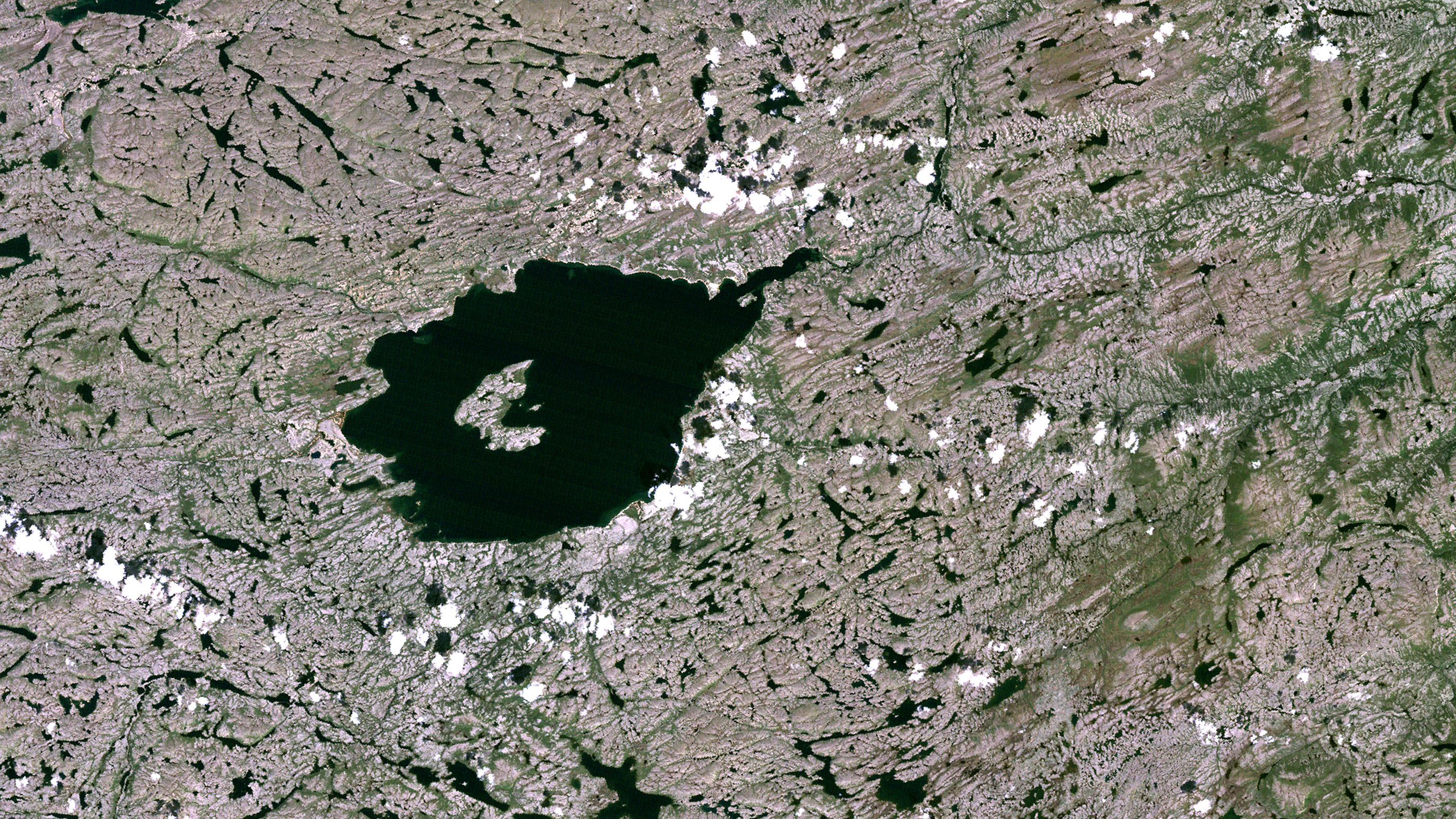 Skała została znaleziona w kraterze uderzeniowym Mistastin widocznym na zdjęciu satelitarnym. Źródło: Planet Observer/Universal Images Group via Getty Images