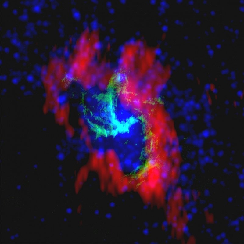 Kompozycja obrazów przedstawiających centralny obszar aktywności naszej Galaktyki - Sagittarius A*. Połączenie obserwacji wykonanych interferometrem radiowym VLA (zieleń), danych z BIMA (czerwień), oraz obserwacji z Teleskopu Spitzera (błękit)