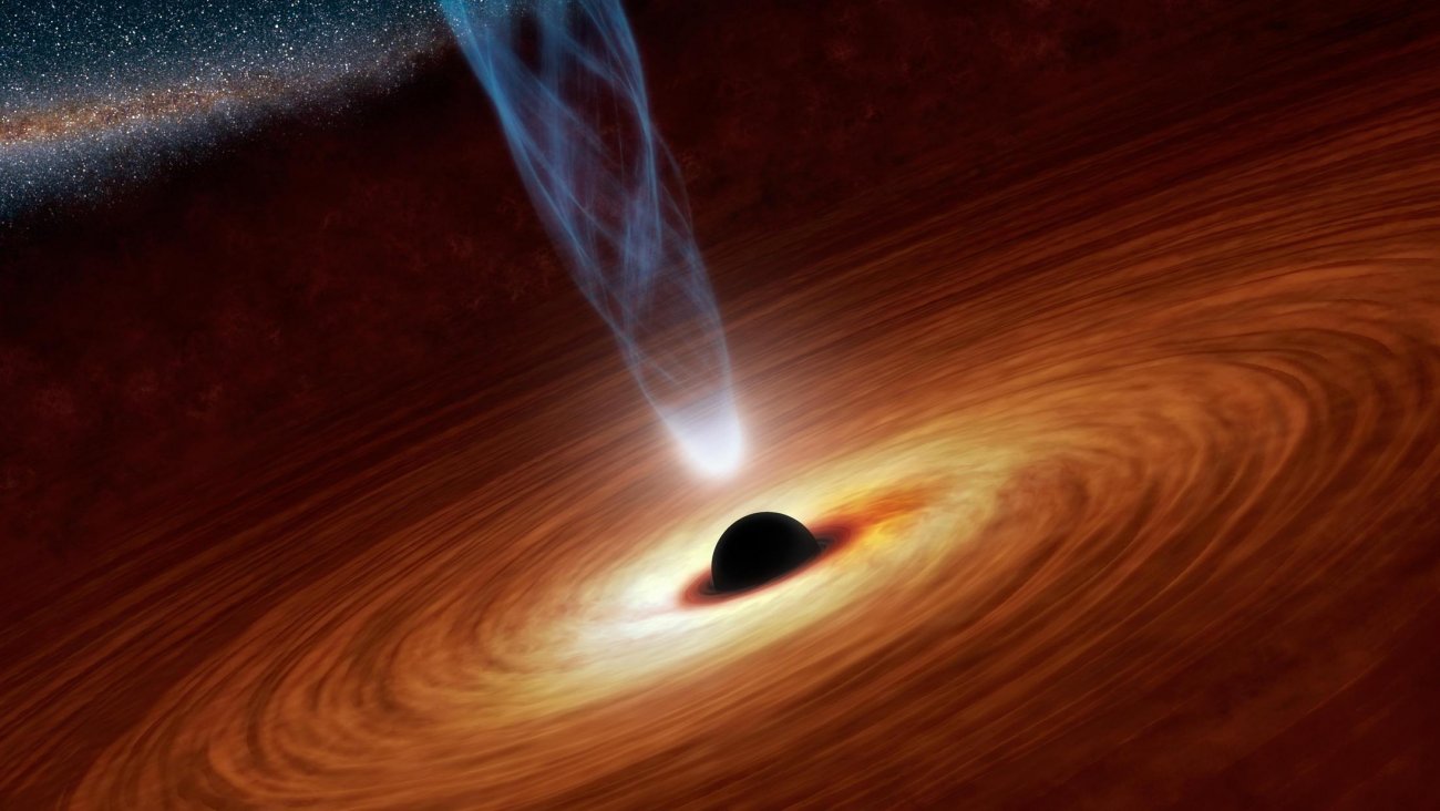 Wizja artystyczna ukazująca supermasywną czarną dziurę otoczoną przez wirującą materię. Na rysunku zaznaczono również obecność strug energetycznych cząstek, zwanych dżetami. Naukowcy uważają, że silnikiem zasilającym dżety jest spin czarnej dziury. Źródło: NASA/JPL-Caltech