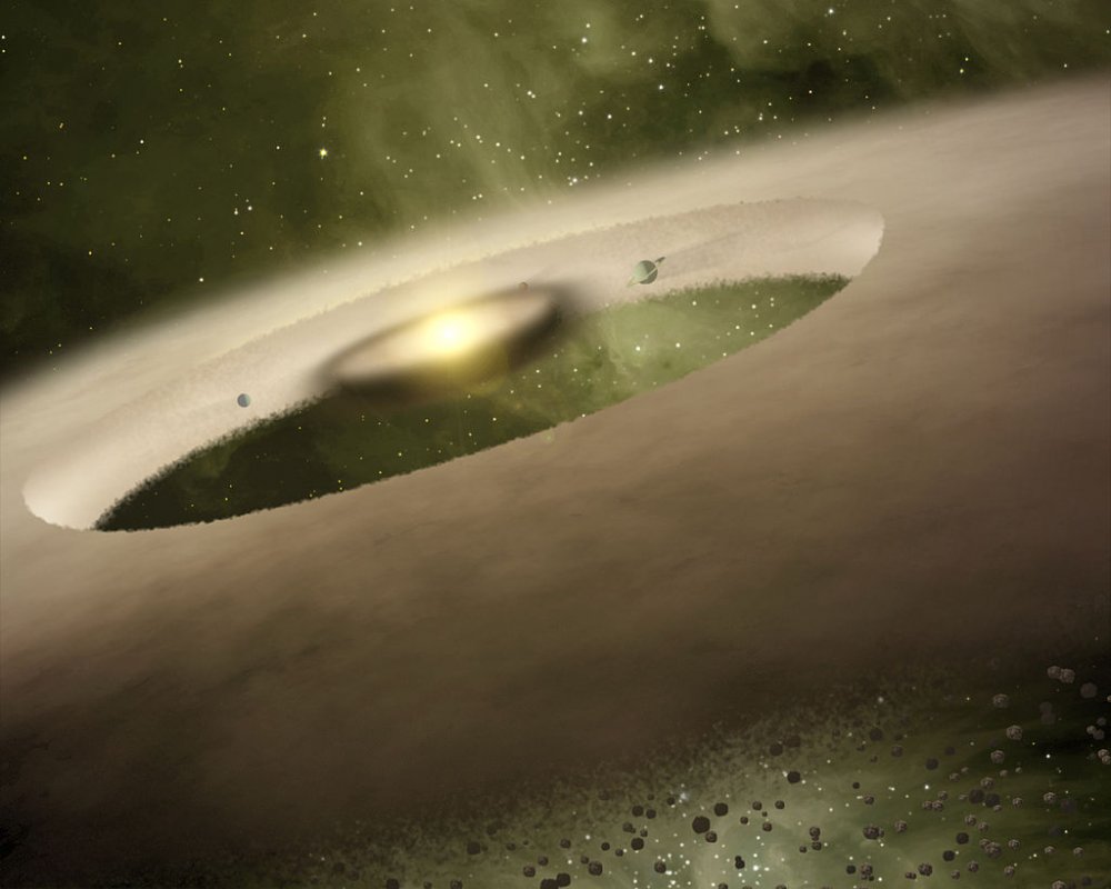 Artystyczna wizja nowo powstającego układu planetarnego wokół gwiazdy UX Tau A (źr:NASA Sptizer Space Telescope)