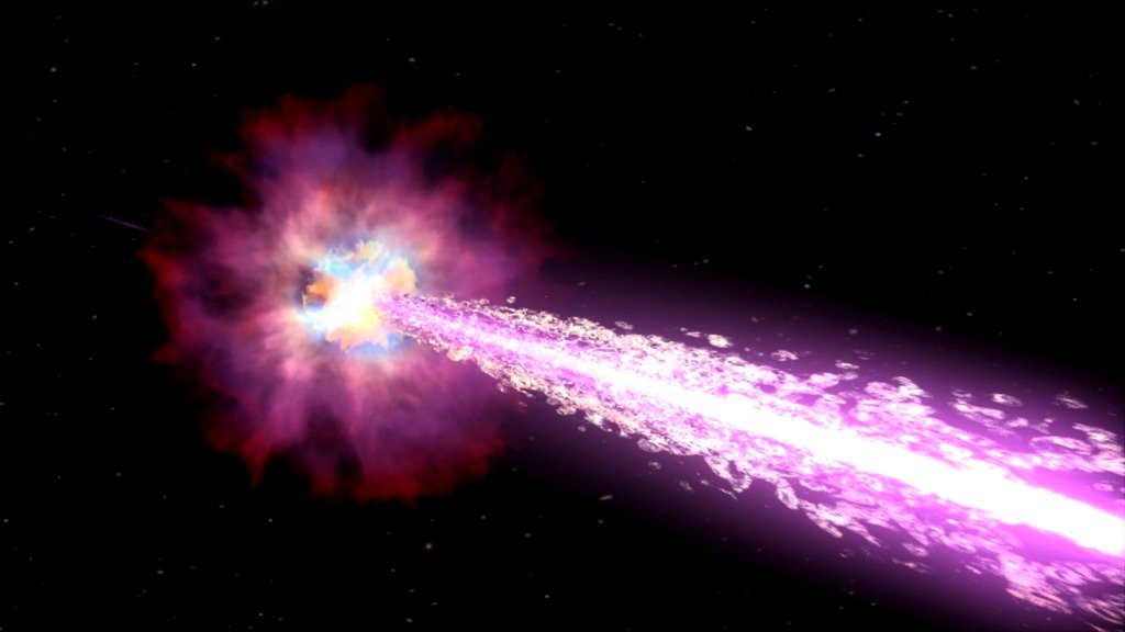 Wizja artystyczna rozbłysku gamma, gdy w wyniku kolapsu jądra masywnej gwiazdy powstaje czarna dziura. Czarna dziura wyrzuca potężne dżety składające się z cząstek, które poruszają się prawie z prędkością światła. Te dżety przeszywają zewnętrzne obszary gwiazdy i emitują promieniowanie rentgenowskie i gamma, gdy rozchodzą się w przestrzeni kosmicznej. Źródło: NASA/Swift/Cruz deWilde