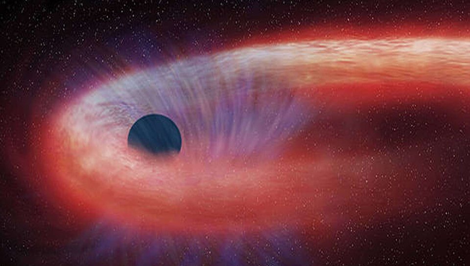 Rozerwanie pływowe gwiazdy przez czarną dziurę.