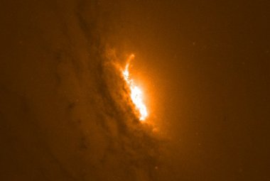 Zdjęcie z Kosmicznego Teleskopu Hubble'a, przedstawiające centralną część galaktyki IC 5063. Jaśniejszy obszar w samym środku to miejsce, w którym dżety plazmy zasilane i napędzane przez supermasywną czarną dziurę z ogromną prędkością wyrzucają materię poza granice galaktyki.