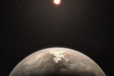 Wizja artystyczna planety Ross 128b z czerwonym karłem w tle